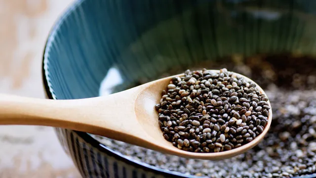 Chia seeds on wooden spoon