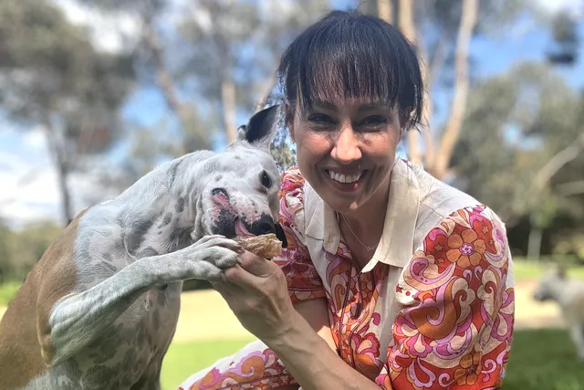 laura v dog behaviourist giving Lyka treat to dog